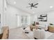 Bright living room offers an open floorplan, neutral decor, and a modern ceiling fan at 1211 Penny Ct, Dunedin, FL 34698