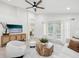 Bright living room featuring modern furniture, ceiling fan, and tile flooring that create an inviting and stylish space at 1211 Penny Ct, Dunedin, FL 34698