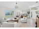 Bright living room boasts neutral decor, a large window, and a stylish seating arrangement at 1211 Penny Ct, Dunedin, FL 34698