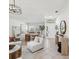 Bright living room with neutral colors, modern furniture, and tile flooring at 1211 Penny Ct, Dunedin, FL 34698