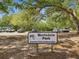 Scottsdale Park sign at entrance with trees and several parked vehicles visible at 1211 Penny Ct, Dunedin, FL 34698