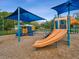 A colorful playground featuring slides, climbing structures, and a variety of engaging activities for children at 1211 Penny Ct, Dunedin, FL 34698