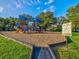 Vibrant playground featuring colorful equipment and safe surfacing, perfect for Gathering fun and outdoor activities in a community park at 1211 Penny Ct, Dunedin, FL 34698