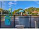 Kiwanis Sprayground featuring colorful water play equipment and a safety fence at 1211 Penny Ct, Dunedin, FL 34698