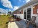 Back porch with sliding glass door, potted plant, and chair at 12400 Park Blvd # 121, Seminole, FL 33772