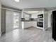 Well-lit kitchen with white cabinetry, mosaic backsplash, and modern appliances next to dining area at 12400 Park Blvd # 121, Seminole, FL 33772