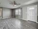 Bright living room with wood-look flooring, neutral walls, and natural light from the front windows at 12400 Park Blvd # 121, Seminole, FL 33772