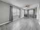 Inviting living room features stylish gray wood-look floors, neutral paint, and ample natural light at 12400 Park Blvd # 121, Seminole, FL 33772