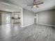 Bright living room featuring new flooring and views of the kitchen and sliding glass doors at 12400 Park Blvd # 121, Seminole, FL 33772