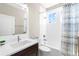 Modern bathroom with white subway tile, dark vanity, and shower-tub combination with a window at 1511 47Th N Ave, St Petersburg, FL 33703
