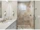 Bathroom featuring a glass shower, neutral tiling, and granite countertops at 1511 47Th N Ave, St Petersburg, FL 33703