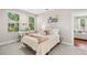 Bright bedroom features a comfy bed, stylish decor and plenty of natural light from the large windows at 1511 47Th N Ave, St Petersburg, FL 33703