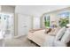 Well-lit bedroom with carpet, windows with views, and a door to the bathroom with a shower and tub at 1511 47Th N Ave, St Petersburg, FL 33703
