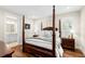 Bedroom featuring a four-poster bed, shuttered windows, and hardwood flooring at 1511 47Th N Ave, St Petersburg, FL 33703