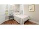Charming bedroom with hardwood floors, plantation shutters, and a cozy bed with patterned bedding at 1511 47Th N Ave, St Petersburg, FL 33703