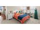 Cozy bedroom with a vibrant bedspread, a sewing machine, and open access to another room at 1511 47Th N Ave, St Petersburg, FL 33703