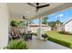 Covered outdoor patio includes comfortable seating and a fan, perfect for enjoying the private fenced backyard at 1511 47Th N Ave, St Petersburg, FL 33703