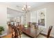 Stylish dining room offers a view to the kitchen and features elegant table, chandelier, and natural light at 1511 47Th N Ave, St Petersburg, FL 33703