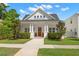 Beautifully landscaped home with a bright red front door, inviting porch, and manicured lawn at 1511 47Th N Ave, St Petersburg, FL 33703