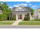 Charming white home featuring a welcoming red front door and a beautifully landscaped front yard at 1511 47Th N Ave, St Petersburg, FL 33703