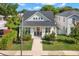 Charming two-story home boasts a manicured lawn and inviting red door, perfect for curb appeal at 1511 47Th N Ave, St Petersburg, FL 33703