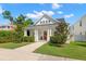 Eye-catching white home with a striking red front door, covered porch, and meticulously maintained yard at 1511 47Th N Ave, St Petersburg, FL 33703