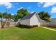 View of detached garage in a well-maintained backyard with lush green grass and privacy fencing at 1511 47Th N Ave, St Petersburg, FL 33703
