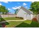 Detached white garage surrounded by a lush green lawn and walkway, offering a serene backyard view at 1511 47Th N Ave, St Petersburg, FL 33703