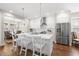 Well-lit kitchen boasts a modern island with bar stools and stainless-steel appliances, perfect for cooking at 1511 47Th N Ave, St Petersburg, FL 33703