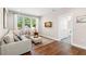 Cozy living room area with hardwood floors, a comfortable couch, and bright natural light at 1511 47Th N Ave, St Petersburg, FL 33703