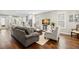 Open-concept living room seamlessly flows into the kitchen, featuring stylish furniture and hardwood floors at 1511 47Th N Ave, St Petersburg, FL 33703