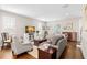 Inviting living room featuring hardwood floors, plantation shutters, and comfortable seating arrangements at 1511 47Th N Ave, St Petersburg, FL 33703
