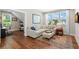 Cozy living room area with hardwood floors, a comfortable couch, and bright natural light at 1511 47Th N Ave, St Petersburg, FL 33703