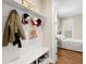 Well-organized mudroom area with a built-in bench, storage for shoes and coats, and access to a charming bedroom at 1511 47Th N Ave, St Petersburg, FL 33703