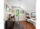 This home office features hardwood flooring, a window for natural light, and functional shelving at 1511 47Th N Ave, St Petersburg, FL 33703