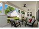 Inviting covered porch featuring stylish furniture, ceiling fans, and a view of the landscaped backyard and garage at 1511 47Th N Ave, St Petersburg, FL 33703
