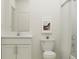 Bright bathroom with white vanity, framed mirror, and shower-tub combination with white tiling at 15276 Rainbow Quartz St, Wimauma, FL 33598