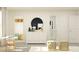 Bright bedroom with white dresser, modern accents, and view into the bathroom at 15276 Rainbow Quartz St, Wimauma, FL 33598