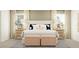 Serene main bedroom with large bed, decorative pillows, and matching nightstands for a balanced design at 15276 Rainbow Quartz St, Wimauma, FL 33598