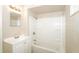 Clean bathroom featuring a tub-shower combo with a white surround, and a vanity with a mirror at 1602 E New Orleans Ave, Tampa, FL 33610