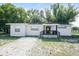 Charming single-story home featuring a covered front porch and gravel landscaping at 1602 E New Orleans Ave, Tampa, FL 33610