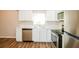 Bright kitchen featuring stainless steel appliances, white cabinets, and ample counter space at 1602 E New Orleans Ave, Tampa, FL 33610
