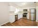 Modern kitchen with stainless steel appliances, white cabinetry, and ample counter space at 1602 E New Orleans Ave, Tampa, FL 33610