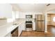 Well-equipped kitchen with white cabinetry, quartz countertops, and stainless steel appliances at 1602 E New Orleans Ave, Tampa, FL 33610