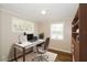 Cozy office features natural light, wood paneling, built-in bookcase, and a stylish desk setup at 1602 E New Orleans Ave, Tampa, FL 33610