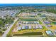 Expansive aerial view showcasing a community with modern homes, serene ponds, and convenient amenities like a pool at 17920 Nadine Pl, Nokomis, FL 34275