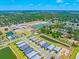 Stunning aerial view of new homes, tranquil ponds, and lush green spaces in a vibrant community setting at 17920 Nadine Pl, Nokomis, FL 34275