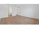 Bright, airy bedroom with wood-look tile flooring and neutral walls, leading to an en-suite bathroom at 17920 Nadine Pl, Nokomis, FL 34275