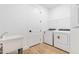 Efficient laundry room with new washer, dryer, utility sink, and convenient storage space at 17920 Nadine Pl, Nokomis, FL 34275