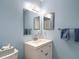 Bright blue bathroom with a vanity, faucet, mirror, and towel rack at 2011 Halidom Way # 0, Sun City Center, FL 33573